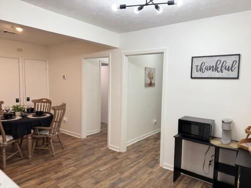 a living room with a table and a dining room at Tiger Suites in Jackson