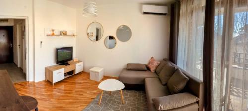 a living room with a couch and a television at Apartman Karingtonka free parking in Vranje