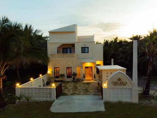 a large white house with lights in front of it at Casa Nala Calicoan - Standard Room in Guiuan