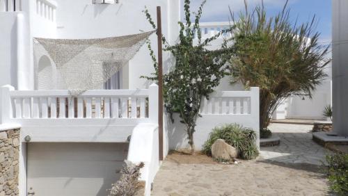 a white house with a white fence and plants at Mykonos Ornos Turquoise Home in Ornos