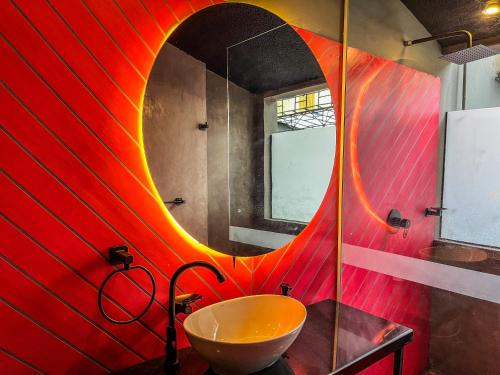 a bathroom with a sink and a mirror at Antonia Poolside Autonomy Hotel in Ibagué
