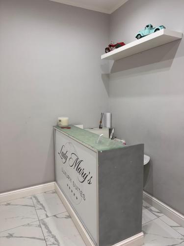 a bathroom with a white toilet in a room at Lady Mary's Luxury Suites in Naples