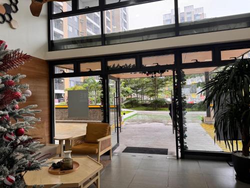 a lobby with a christmas tree and a glass door at Mon Amour Haven in Taytay