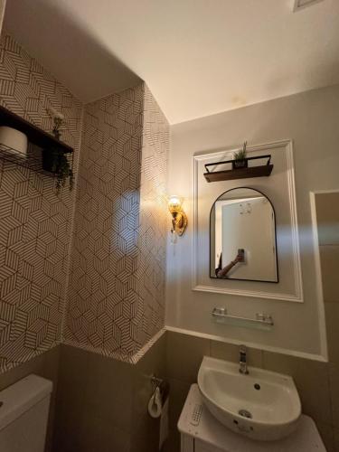 a bathroom with a sink and a mirror at Mon Amour Haven in Taytay