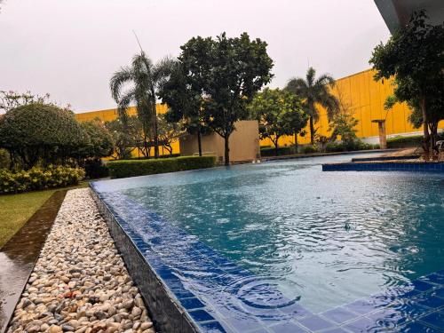 a swimming pool with blue water in front of a building at Mon Amour Haven in Taytay
