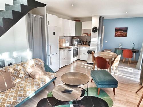a living room with a couch and a table at Au sommet des Ocres et des Bois - Maison T3 & Parking in Roussillon