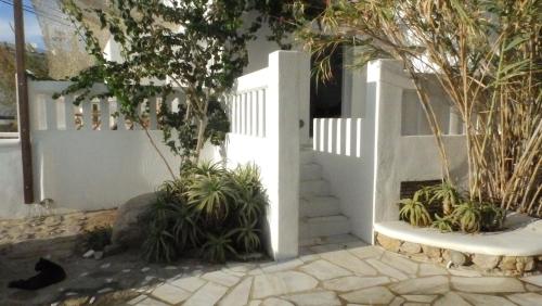 a white fence with plants in front of a house at Mykonos Ornos Turquoise Home in Ornos