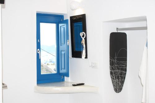 a blue door and a window on a wall at Mary Castelia Villa with Jacuzzi in Akrotiri