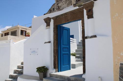 a blue door on a white building with stairs at Mary Castelia Villa with Jacuzzi in Akrotiri