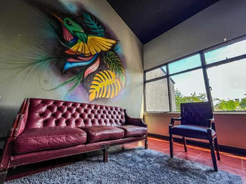 a living room with a couch and a chair at Antonia Poolside Autonomy Hotel in Ibagué