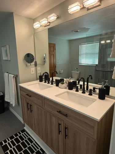 a bathroom with a sink and a large mirror at Pool home on the Bay, large private yard near AMI in Bradenton