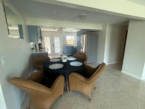 a dining room with a black table and chairs at Pool home on the Bay, large private yard near AMI in Bradenton