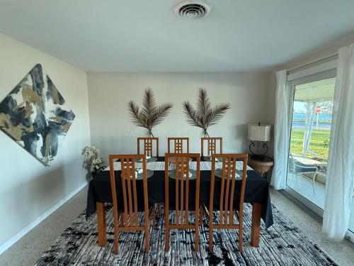 a dining room with a table and chairs at Pool home on the Bay, large private yard near AMI in Bradenton