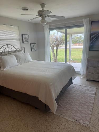 a bedroom with a large bed and a window at Pool home on the Bay, large private yard near AMI in Bradenton
