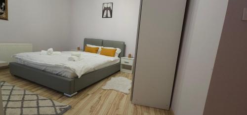 a bedroom with a bed in front of a mirror at Sinaia Mountain View Residence Belleview in Sinaia