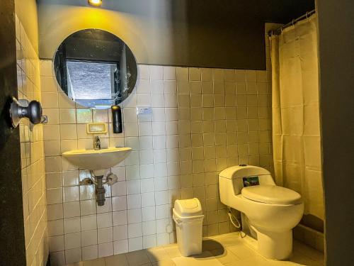 a bathroom with a toilet and a sink at Antonia Poolside Autonomy Hotel in Ibagué
