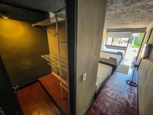 a room with two bunk beds and a room with a room with two beds at Antonia Poolside Autonomy Hotel in Ibagué