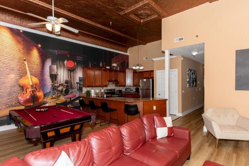 a living room with a couch and a pool table at The Jazz Club Downtown Sandusky in Sandusky