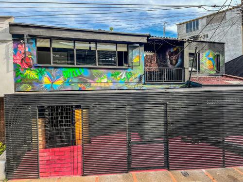 a building with a painting on the side of it at Antonia Poolside Autonomy Hotel in Ibagué