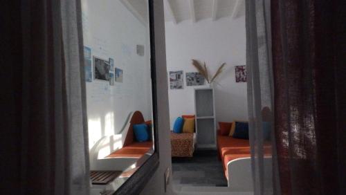 a living room with a couch and a mirror at Mykonos Ornos Turquoise Home in Ornos