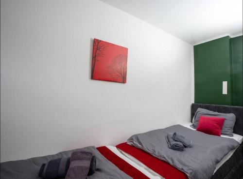 a bedroom with a bed with a red picture on the wall at Livemore24 - Apartment 2 in Oer-Erkenschwick WLAN in Oer-Erkenschwick