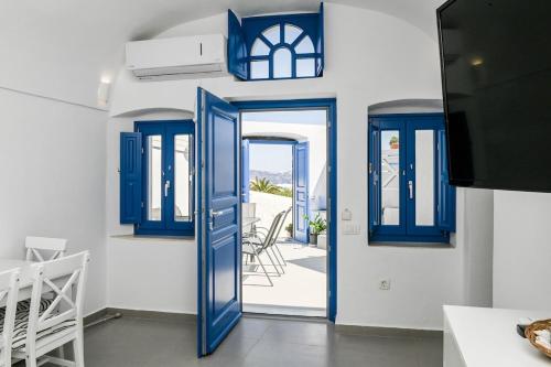 a blue door leading into a room with a patio at Mary Castelia Villa 2 with Jacuzzi in Akrotiri