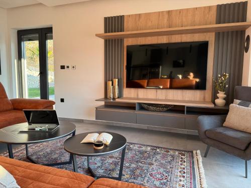 a living room with a large flat screen tv at Alta Vista residence&spa in Mostar