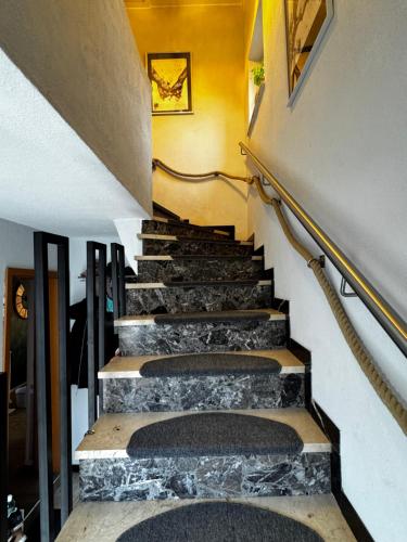 a set of stairs in a building with stone steps at Ferienwohnung Weitblick in Erftstadt