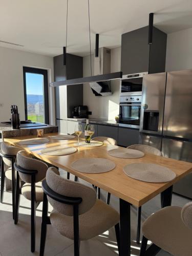 a kitchen with a wooden table and some chairs at Alta Vista residence&spa in Mostar