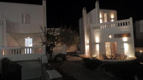 a white house at night with lights on it at Mykonos Ornos Turquoise Home in Ornos