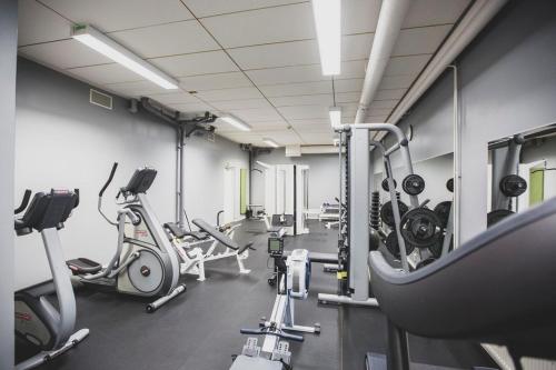 a gym with several treadmills and cardio machines at Majvik Congress Hotel in Kirkkonummi