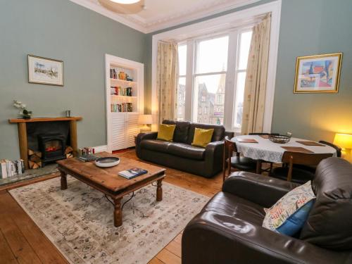 a living room with a couch and a table at Struan House in Aberfeldy
