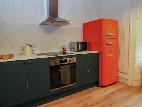 a kitchen with a red refrigerator and a stove at Struan House in Aberfeldy