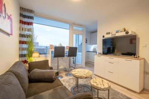 a living room with a couch and a flat screen tv at Waldperle in Altenau