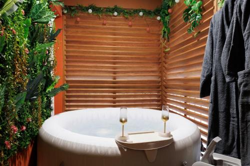 a bath tub with two wine glasses sitting in it at L'Eldorado - DestinationGuyane in Bourda