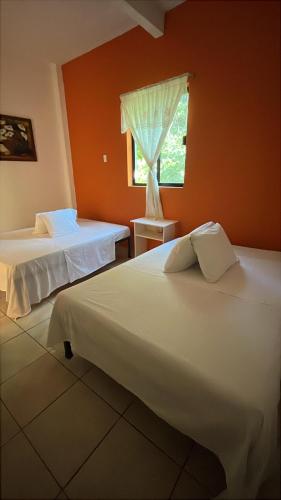 twee bedden in een kamer met een raam bij Hotel La Mansion del General in Tampico