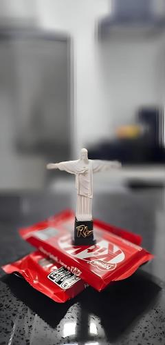 a toy figure sitting on top of a red table at Copacabana Vibes Studios in Rio de Janeiro