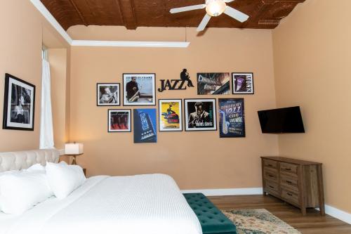 a bedroom with a bed and pictures on the wall at The Jazz Club Downtown Sandusky in Sandusky
