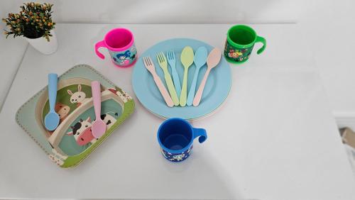 a table with plates and cups and utensils at Copacabana Vibes Studios in Rio de Janeiro