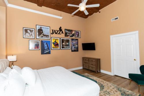 a bedroom with a bed and pictures on the wall at The Jazz Club Downtown Sandusky in Sandusky