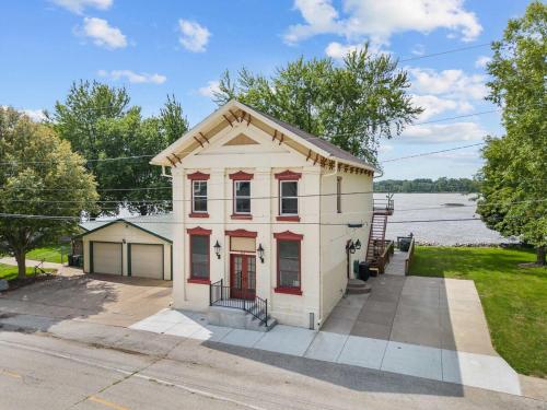 a small white house on the side of the street at Charming Cottage on the Mississipi River in Pleasant Valley