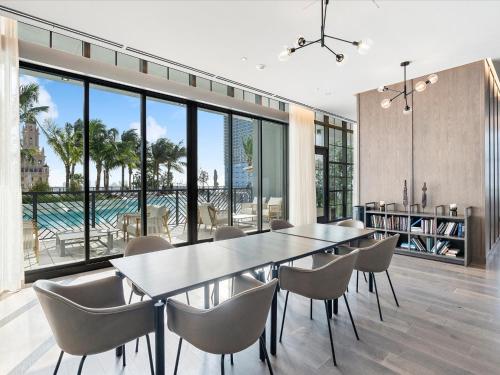 a dining room with a table and chairs at Private Beach Club Access & Stunning Ocean Views in Miami