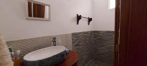 a bathroom with a sink and a mirror at Tamarin Beach House in Tamarin