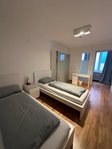 a bedroom with two beds and a mirror at Al Nafurah Apartments in Munich