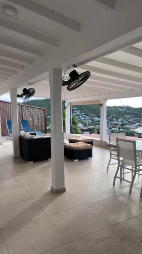 a living room with a couch and chairs on a balcony at Casa dulce - Camaruche in Saint Barthelemy