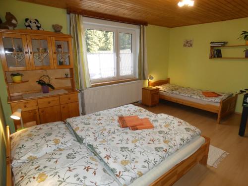 a bedroom with two beds and a window at Forester Apartment Zuberec in Zuberec