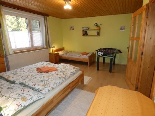 a bedroom with two beds and a table in it at Forester Apartment Zuberec in Zuberec