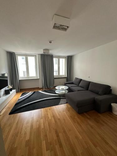 a living room with a couch and a table at Al Nafurah Apartments in Munich