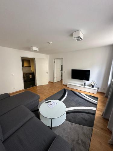 a living room with a couch and a table at Al Nafurah Apartments in Munich