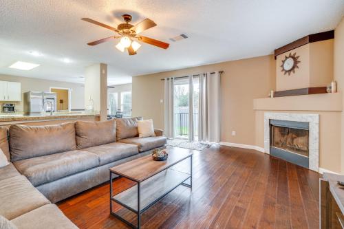 a living room with a couch and a fireplace at 6 Mi to Lake Travis Spacious Cedar Park Home! in Cedar Park